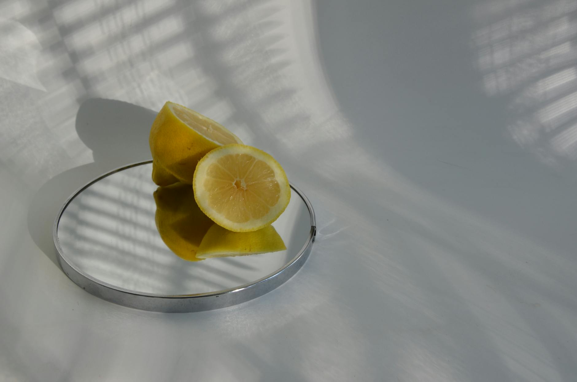 Close-up of a hand holding an orange vibrator against a minimalistic purple backdrop, showcasing modern sensuality.