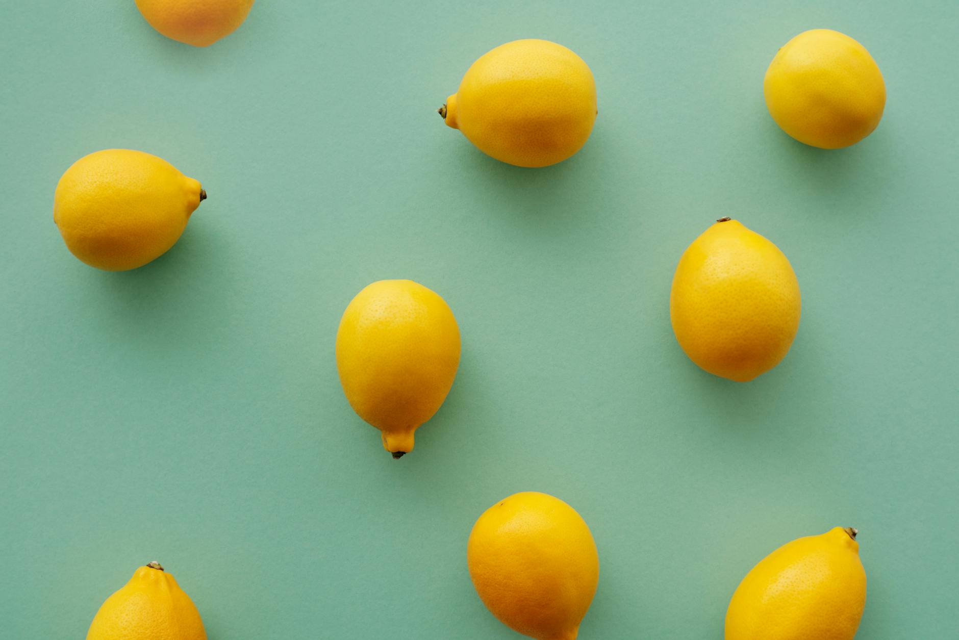 Bright lemons arranged on pastel background, symbolizing fresh approaches to menopause and pleasure
