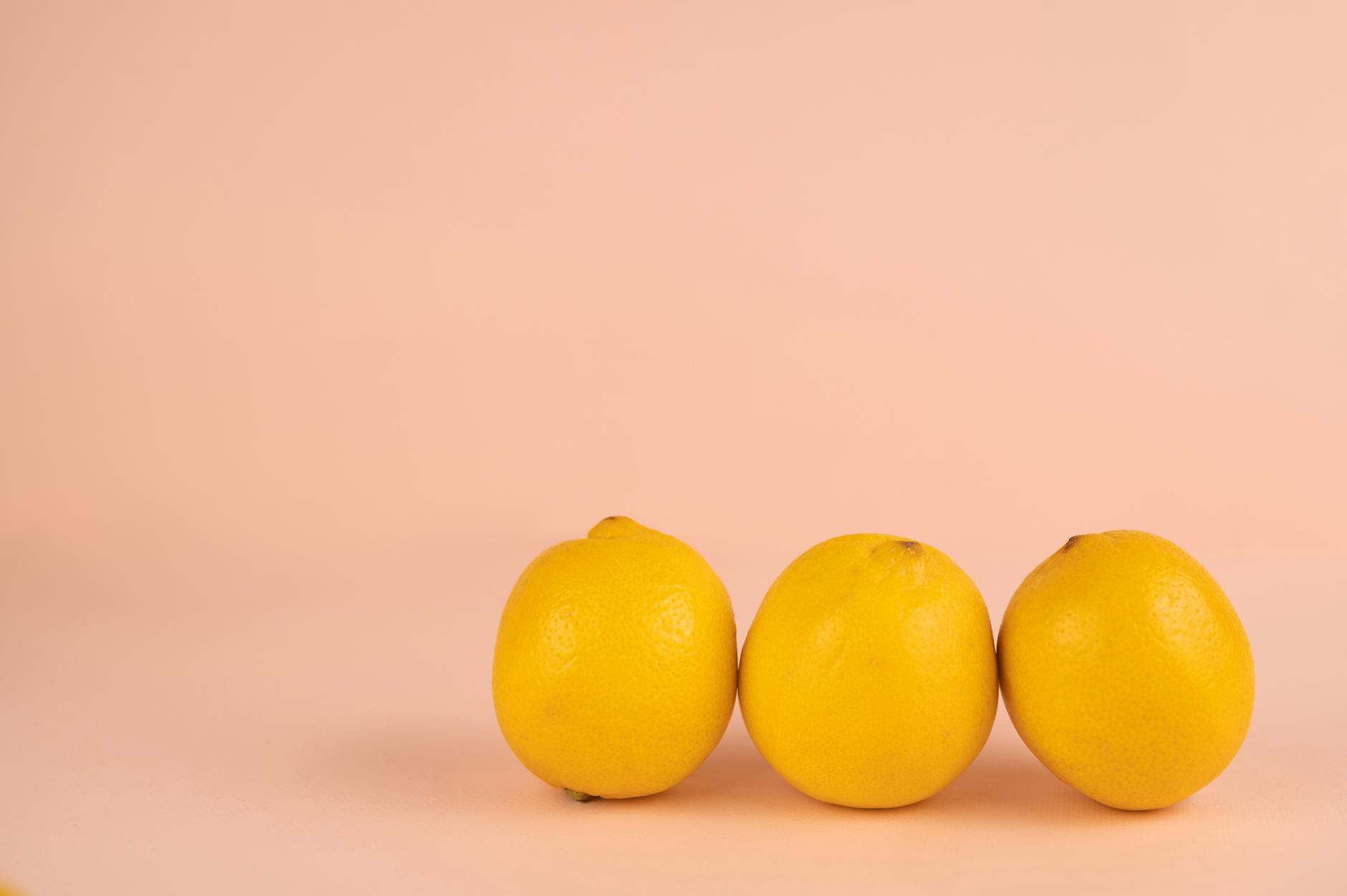 Bright ripe lemons on a pastel background, symbolizing fresh approaches to intimacy